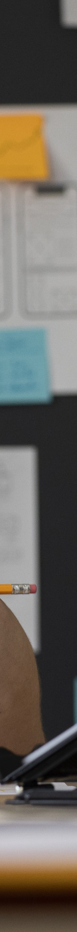 Female Web Designer With Papers Notes Office